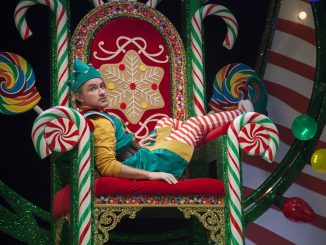 An elf sits on a throne.